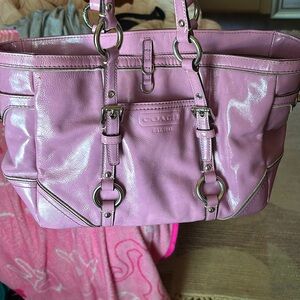 This is a Bucket purse from Coach in a purple pink with silver hardware.